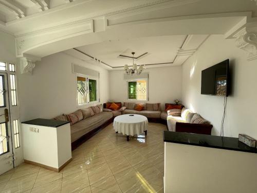 a living room with a couch and a table at Apartment in a beachfront house in Briyech