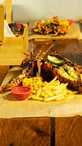 a plate of food on a wooden table with food at Viva O Sonho 