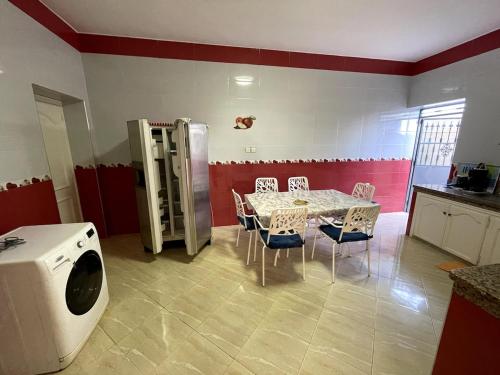 a dining room with a table and a refrigerator at Apartment in a beachfront house in Briyech