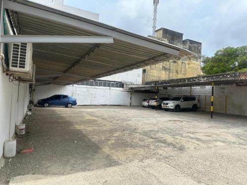a parking lot with cars parked in a garage at Hotel Caribana Express in Barranquilla