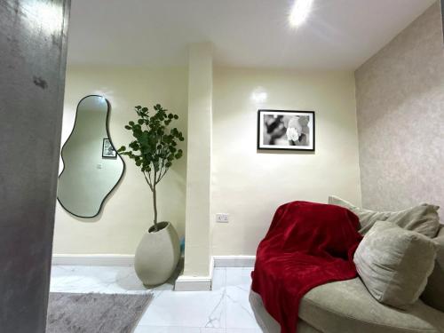 a living room with a couch and a guitar at Mex studio apartment banana island road ikoyi in Lagos