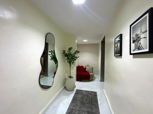 a living room with a mirror and a red couch at Mex studio apartment banana island road ikoyi in Lagos