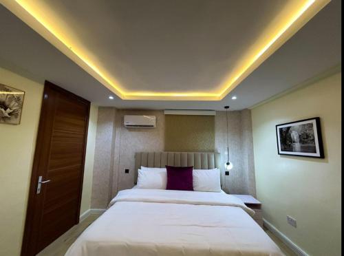 a bedroom with a large bed in a room at Mex studio apartment banana island road ikoyi in Lagos