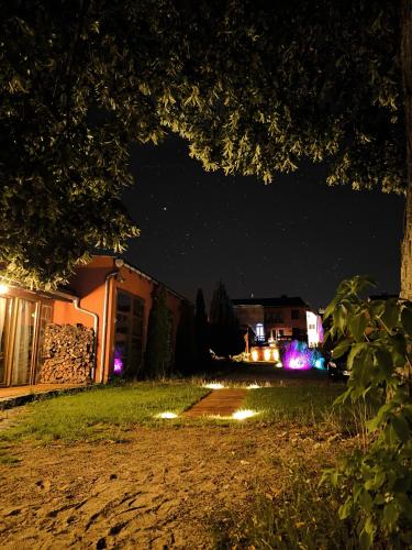 a night view of a house with lights in the yard at Cour De Berlin in Fürstenberg