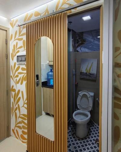 a bathroom with a toilet and a mirror at Hotel De Rama Unit 1230 near MOA & NAIA in Manila