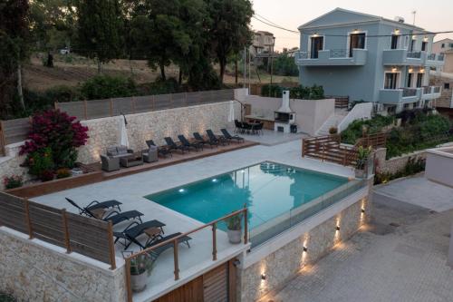 a swimming pool on top of a house at Marios Suite Corfu in Corfu