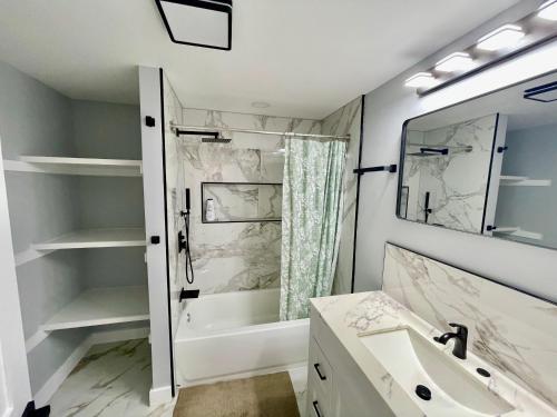 a bathroom with a tub and a sink and a shower at Oak House in Silver Spring