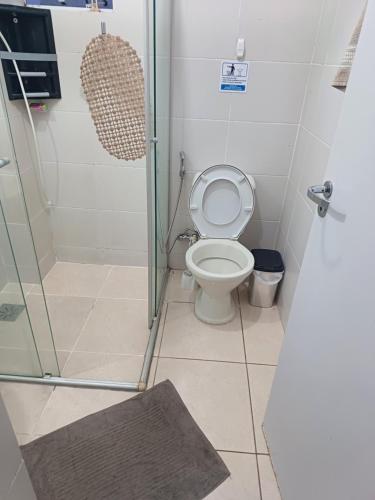 a bathroom with a toilet and a glass shower at Apart próximo a Unimed de 2 quartos com Ac e garagem in Santo Ângelo