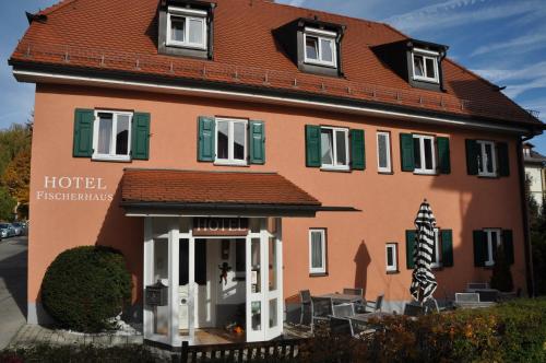 a building with a hotel in front of it at Hotel Fischerhaus in Starnberg
