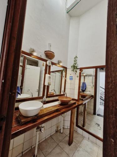 a bathroom with two sinks and two mirrors at WHY NOT NUEVA CORDOBA in Cordoba