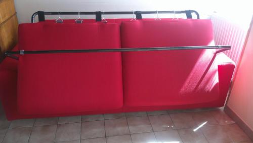 a red refrigerator with four redartments in a room at Maison entre Cherbourg et Mont Saint Michel in Saint-Aubin-du-Perron