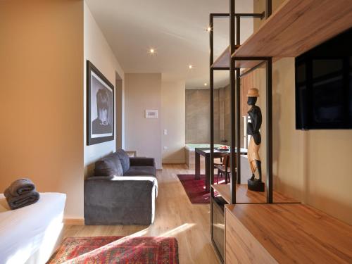 a living room with a mannequin standing next to a couch at Luxury Studios & Cozy Apartments by White Hills in Arachova