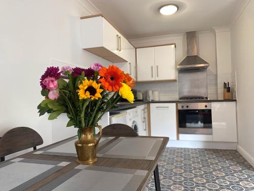 ケンブリッジにあるExpert Stays 2 BR near River Cam Central Cambridgeの台所のテーブルに座る花瓶
