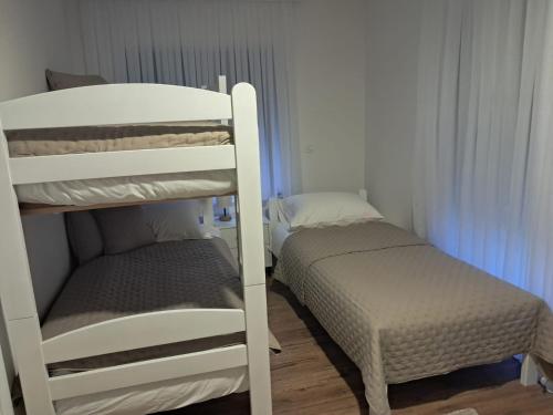 a small bedroom with a bunk bed next to a bunk bedouble at Galija in Tomislavgrad