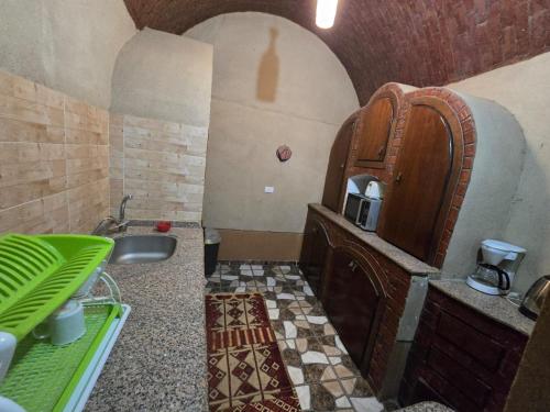 a bathroom with a sink and a wooden cabinet at Villa Harmony Luxor in Luxor