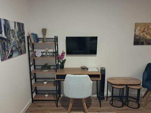 a desk with a computer and a chair in a room at Galija in Tomislavgrad