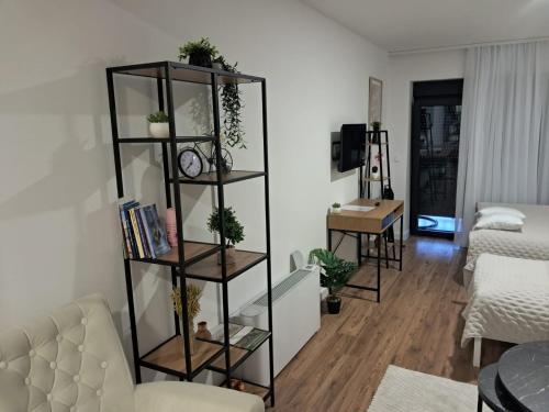 a living room with a black book shelf at Galija in Tomislavgrad