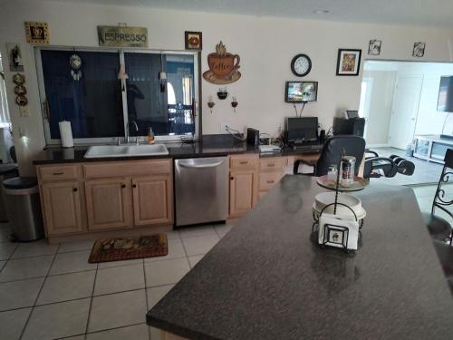 a kitchen with a sink and a counter top at TheTotal Florida life style heated pool 5 bedrooms in Punta Gorda