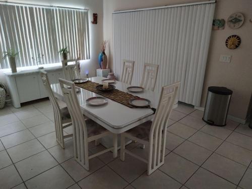 a white table and chairs in a room with a table and chairsktop at TheTotal Florida life style heated pool 5 bedrooms in Punta Gorda