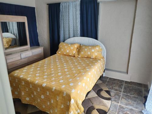 a room with a bed and a mirror and a chair at TheTotal Florida life style heated pool 5 bedrooms in Punta Gorda