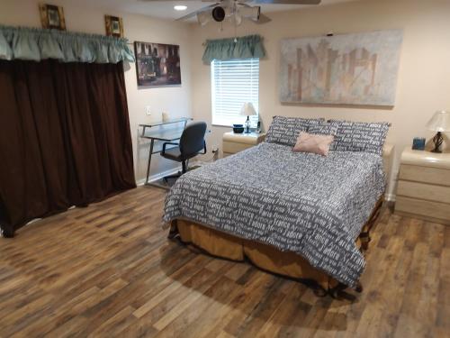 a bedroom with a bed and a desk at TheTotal Florida life style heated pool 5 bedrooms in Punta Gorda