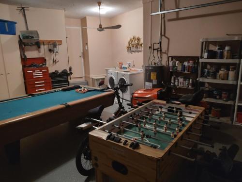 a room with a pool table and a table at TheTotal Florida life style heated pool 5 bedrooms in Punta Gorda