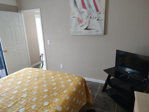 a bedroom with a bed and a flat screen tv at TheTotal Florida life style heated pool 5 bedrooms in Punta Gorda