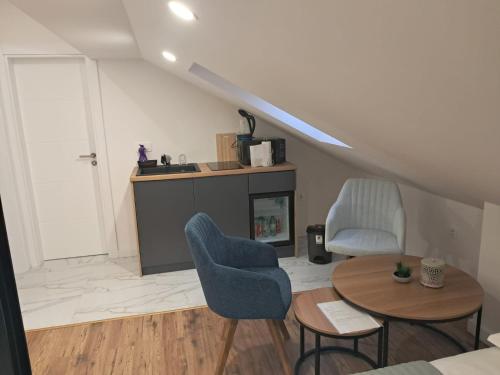 a living room with two chairs and a table at Galija in Tomislavgrad