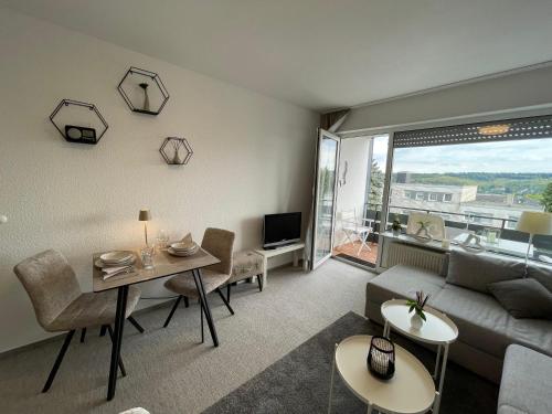 a living room with a couch and a table at Ferienapartment Zeit am See 