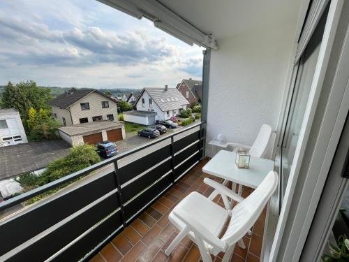 a balcony with a table and chairs and a view at Ferienapartment Zeit am See 