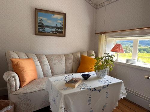 a living room with a couch and a table at Solberg Inn 