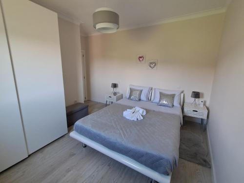 a bedroom with a bed with a towel on it at Ninho das Andorinhas in Monção