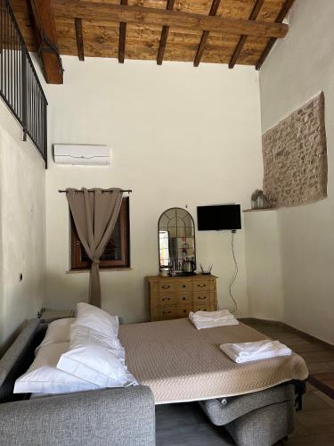 a bedroom with a bed and a television in it at Borgo delle Mole in Spoleto