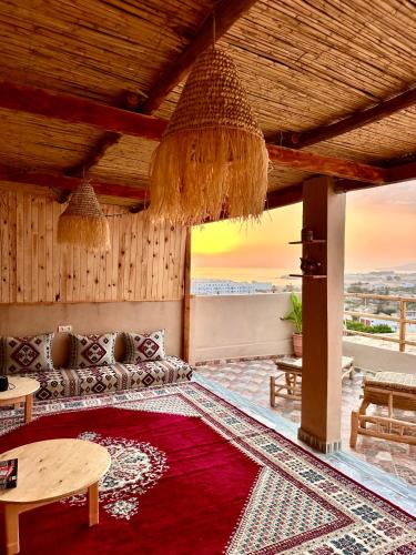 a living room with a couch and a table at Balance Surf Morocco , Quality rooms , Moroccan food , Activities in Aourir