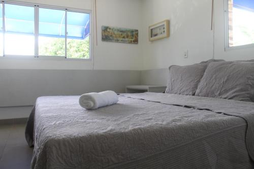 a bed with a rolled up towel on top of it at Casa Luxuosa - Porto de Galinhas in Porto De Galinhas