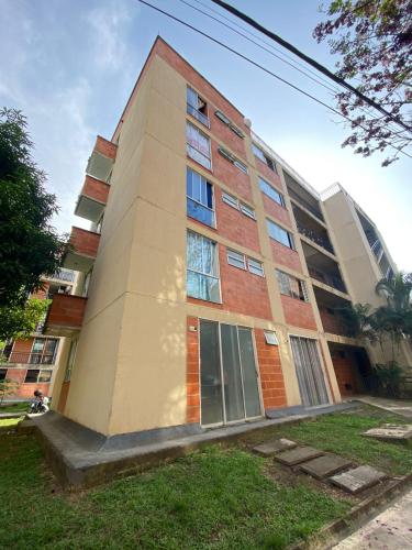 a tallartment building with windows on the side of it at Hotel Puerta del Sol de Uraba in Apartadó