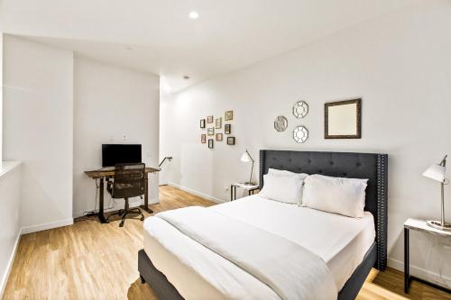 a bedroom with a large bed and a desk at Posh Lofty Pad in Central Redmond - 92 Walkscore! in Redmond