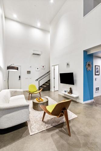 a living room with a couch and a tv at Posh Lofty Pad in Central Redmond - 92 Walkscore! in Redmond