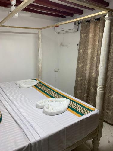 Postel nebo postele na pokoji v ubytování Fatnaish Tamarind Apartment