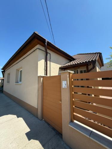 a wooden fence in front of a house at BellaRóza in Solt