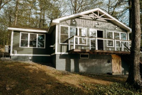 a house with a porch on the side of it at Tri-Lake Escape in Naples