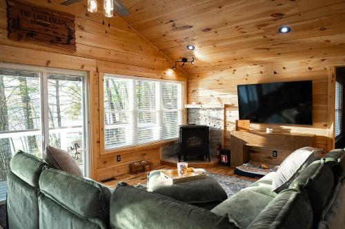 a living room with a couch and a flat screen tv at Tri-Lake Escape in Naples