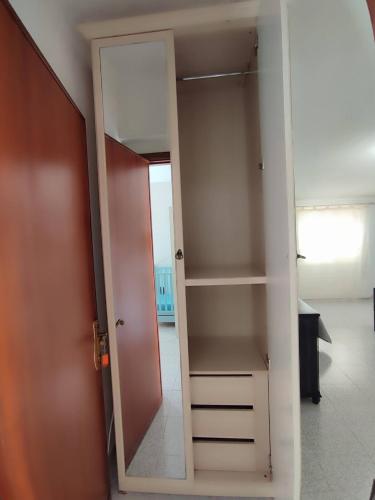 a closet with a door open to a room at Family & Friends - Room 2 - Second Floor - shared bathroom in Galtellì