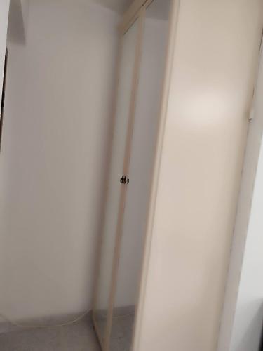 a room with a white wall and a door at Family & Friends - Room 2 - Second Floor - shared bathroom in Galtellì