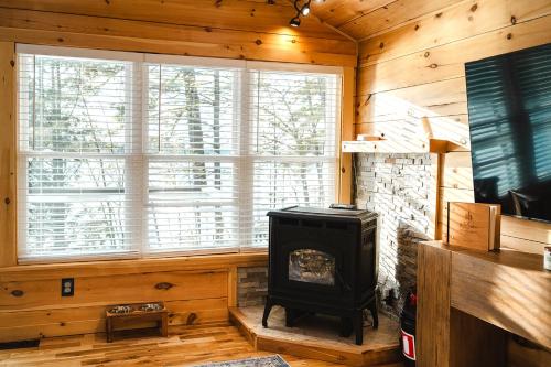 a living room with a fireplace and a stove at Tri-Lake Escape in Naples