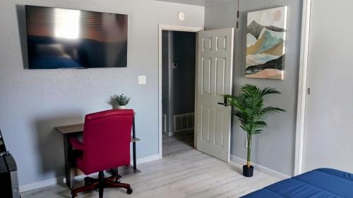 a bedroom with a desk and a red chair at Modern Industrial Oasis Private Room with King Bed WiFi FREE Parking and More in Alamogordo