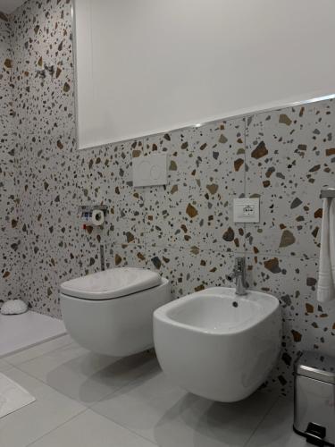 a bathroom with a white sink and a toilet at SunBeach 44 - Skyview B&B in Melito di Porto Salvo
