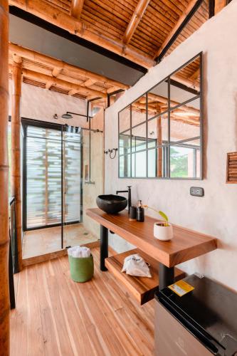 a kitchen with a wooden counter and a sink at Kawa Bamboo Retreat in Pereira