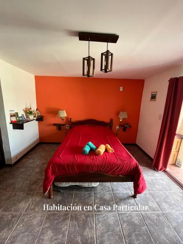 a red bed with a stuffed animal laying on it at Refugio del Alma in San Rafael