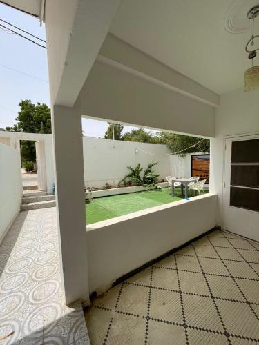 a room with a patio with a green lawn at Saada Apartments in Nouakchott